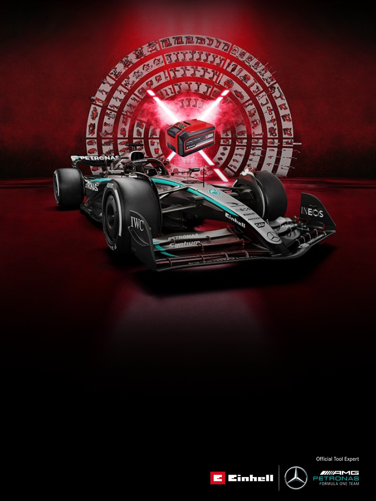 A Mercedes-AMG PETRONAS Formula 1 car is set against a vibrant red background featuring an Einhell battery at the center. The Einhell and Mercedes-AMG PETRONAS F1 Team logos are displayed in the bottom right corner. 