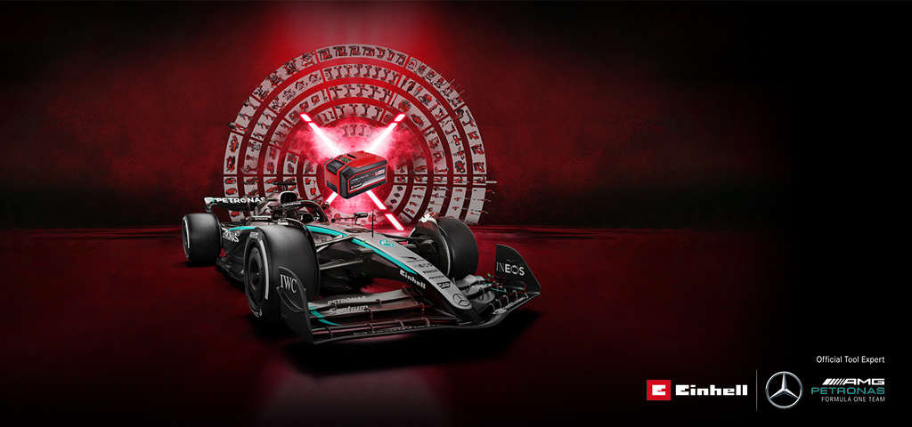 A Mercedes-AMG PETRONAS Formula 1 car is set against a vibrant red background featuring an Einhell battery at the center. The Einhell and Mercedes-AMG PETRONAS F1 Team logos are displayed in the bottom right corner.