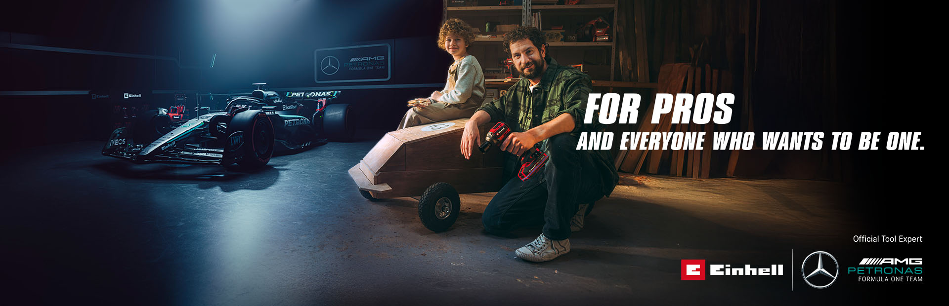 A father and child in a workshop with a homemade soapbox car. In the background, a Mercedes-AMG PETRONAS Formula One car and Einhell tools. Text on the right reads: "For professionals and those who want to become one."