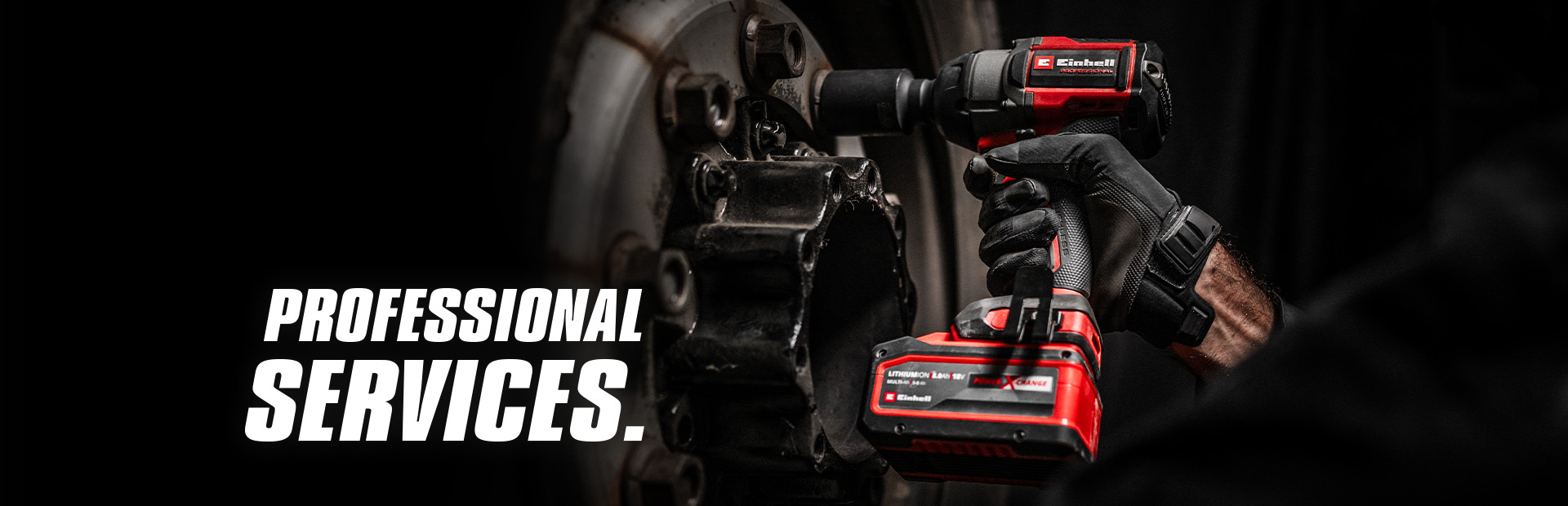 Close-αup of a red cordless impact wrench being used on a wheel, with the text "Professional Services".